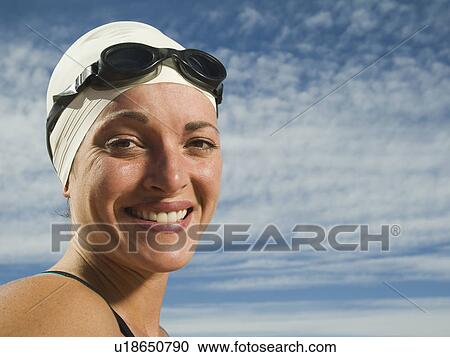 Stock Image - Woman wearing swimming cap and goggles, Utah, United States. Fotosearch