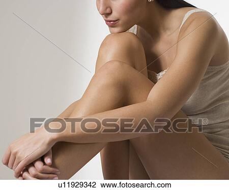 Woman with arms around bare legs View Large Photo Image Stock Image - Woman with arms around bare legs. Fotosearch