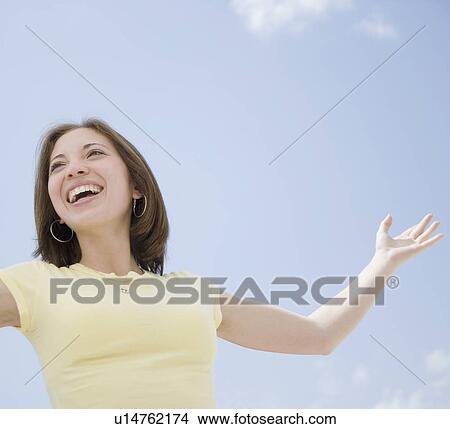 Woman with arms raised View Large Photo Image Picture - Woman with arms raised. Fotosearch
