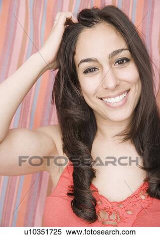 Stock Photography - Woman with hand in hair. Fotosearch