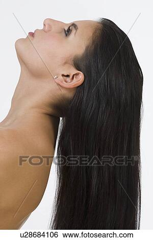 Stock Photograph - Woman with long hair tilting head back. Fotosearch