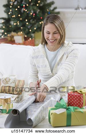 Woman wrapping Christmas gifts View Large Photo Image Picture - Woman wrapping Christmas gifts. Fotosearch