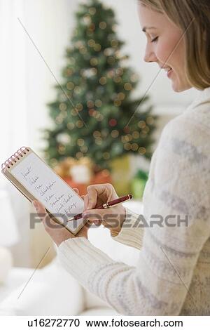 Stock Image - Woman writing list. Fotosearch