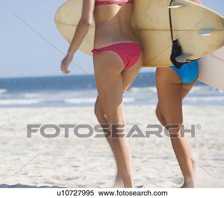 Women in bikinis carrying surfboards View Large Photo Image Stock Photography - Women in bikinis carrying surfboards. Fotosearch