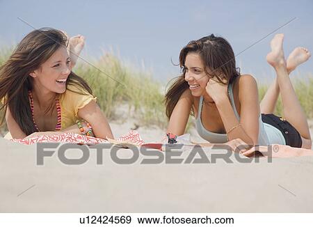 Women laying on beach blankets View Large Photo Image Stock Photo - Women laying on beach blankets. Fotosearch
