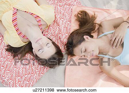 Women laying on beach blankets View Large Photo Image Stock Photo - Women laying on beach blankets. Fotosearch