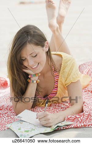 Women writing letter at beach View Large Photo Image Stock Image - Women writing letter at beach. Fotosearch