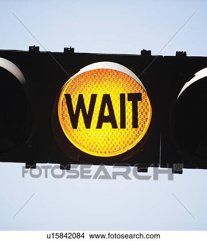 Picture - Yellow traffic light reading Wait. Fotosearch