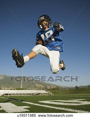 Young football player jumping View Large Photo Image Stock Photography - Young football player jumping. Fotosearch