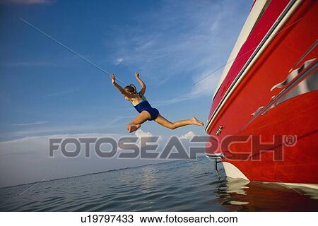 Young girl jumping off boat, Florida, United States View Large Photo Image Stock Image - Young girl jumping off boat, Florida, United States. Fotosearch