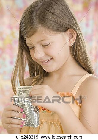 Young girl putting money in change purse View Large Photo Image Stock Photo - Young girl putting money in change purse. Fotosearch