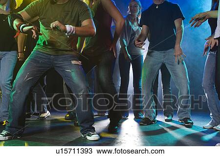 Stock Image - Young people at dance club. Fotosearch