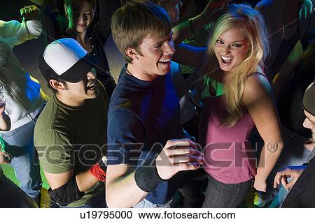 Stock Image - Young people at dance club. Fotosearch