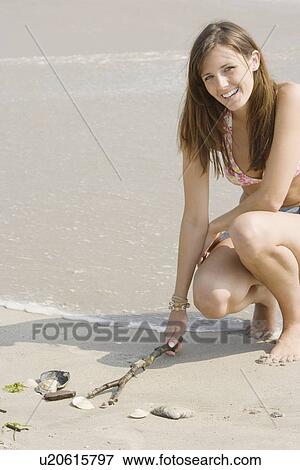 Stock Photo - Young woman at beach. Fotosearch