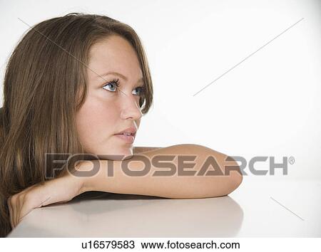 Young woman leaning chin on arm View Large Photo Image Stock Image - Young woman leaning chin on arm . Fotosearch
