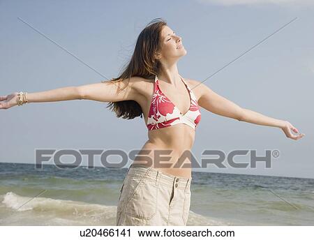 Young woman with arms outstretched View Large Photo Image Stock Image - Young woman with arms outstretched. Fotosearch