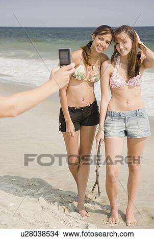 Picture - Young women having photograph taken. Fotosearch