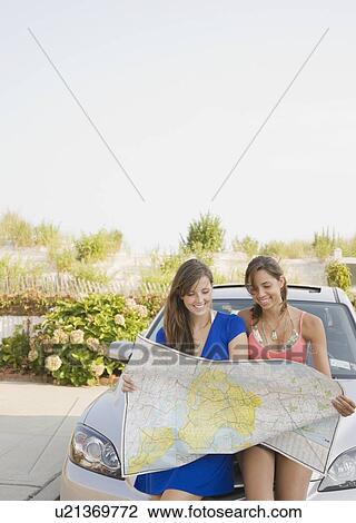 Young women looking at map View Large Photo Image Stock Image - Young women looking at map. Fotosearch