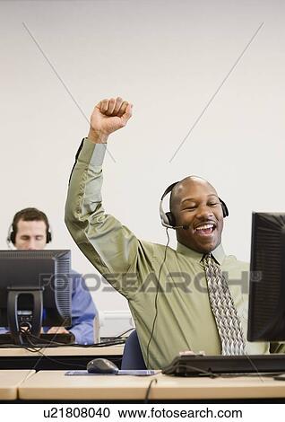 Stock Image - African businessman cheering. Fotosearch