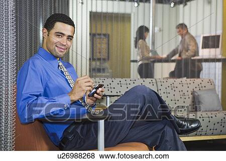 African businessman dialing cell phone View Large Photo Image Stock Photo - African businessman dialing cell phone. Fotosearch