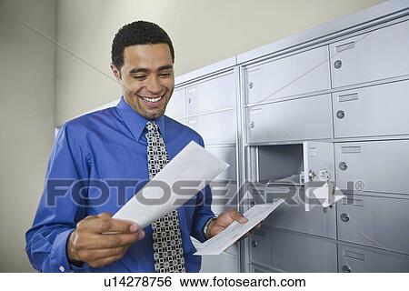 African businessman reading mail View Large Photo Image Stock Photograph - African businessman reading mail. Fotosearch