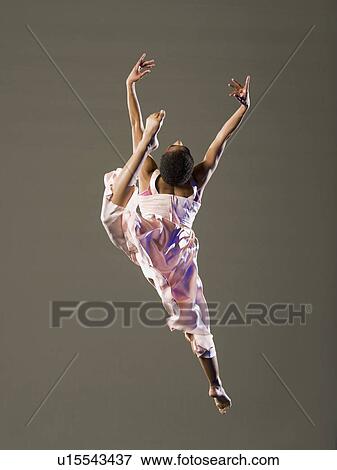 Stock Photo - African female ballet dancer jumping. Fotosearch