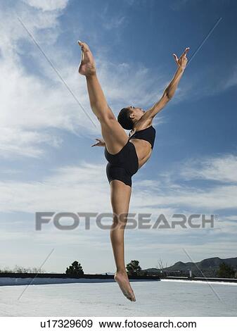 Stock Photo - African female ballet dancer jumping. Fotosearch