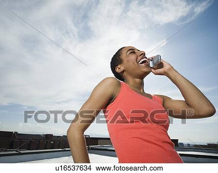 African woman talking on cell phone View Large Photo Image Picture - African woman talking on cell phone. Fotosearch