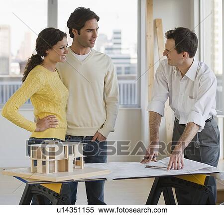 Architect presenting blueprints to couple View Large Photo Image Stock Photography - Architect presenting blueprints to couple. Fotosearch