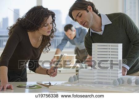 Stock Photo - Architects constructing building model. Fotosearch