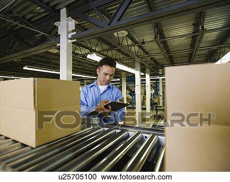 Asian male factory worker checking product View Large Photo Image Stock Image - Asian male factory worker checking product. Fotosearch