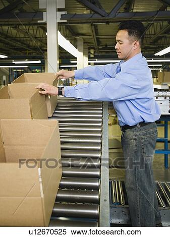 Asian male factory worker checking product View Large Photo Image Stock Photography - Asian male factory worker checking product. Fotosearch