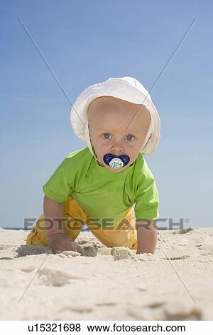 Baby boy crawling on beach View Large Photo Image Stock Photo - Baby boy crawling on beach. Fotosearch