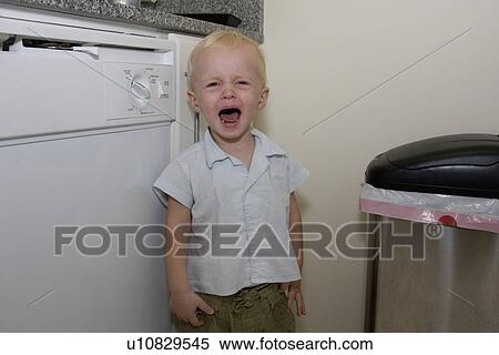 Baby boy crying in kitchen View Large Photo Image Stock Photography - Baby boy crying in kitchen. Fotosearch