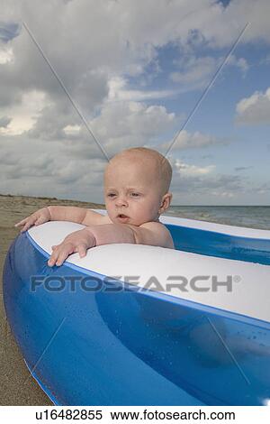 Baby boy sitting in inflatable swimming pool View Large Photo Image Stock Photography - Baby boy sitting in inflatable swimming pool. Fotosearch