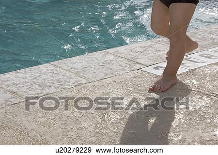 Baby boy walking at edge of swimming pool View Large Photo Image Stock Photo - Baby boy walking at edge of swimming pool. Fotosearch