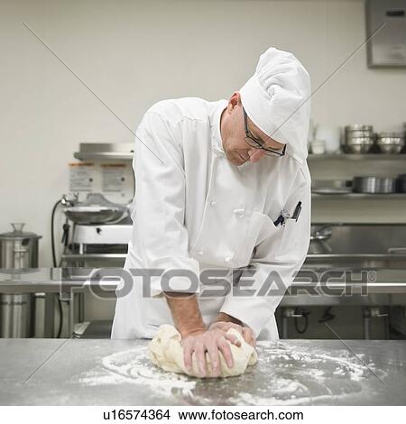 Picture - Baker kneading bread dough. Fotosearch