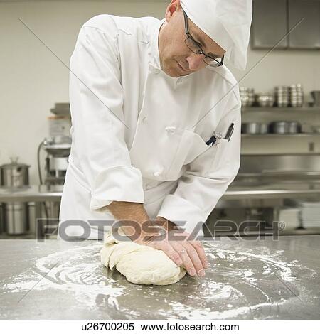 Stock Photography - Baker kneading bread dough. Fotosearch