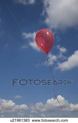 Stock Image - Balloon floating into sky. Fotosearch