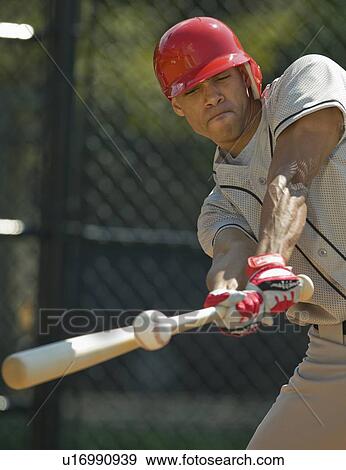 Stock Photo - Baseball batter hitting ball. Fotosearch