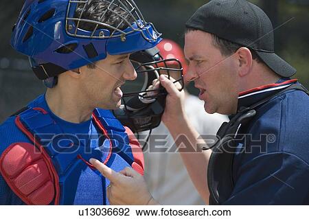 Stock Image - Baseball catcher arguing with umpire. Fotosearch