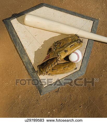Stock Image - Baseball equipment on home plate. Fotosearch