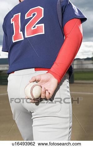 Stock Image - Baseball pitcher getting ready to throw ball. Fotosearch