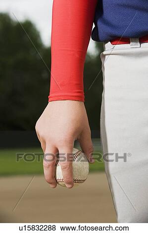 Stock Photo - Baseball pitcher getting ready to throw ball. Fotosearch
