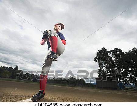 Stock Photography - Baseball pitcher getting ready to throw ball. Fotosearch