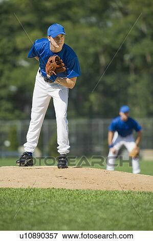 Stock Photo - Baseball pitcher preparing to pitch ball. Fotosearch