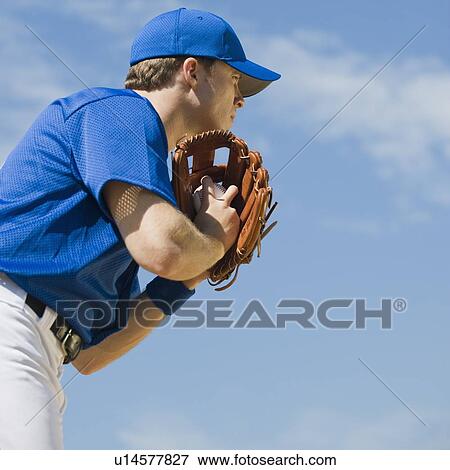Stock Photo - Baseball pitcher preparing to pitch ball. Fotosearch