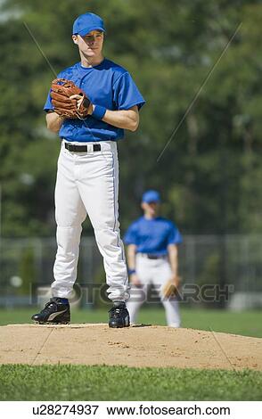 Baseball pitcher preparing to pitch ball View Large Photo Image Stock Photo - Baseball pitcher preparing to pitch ball. Fotosearch