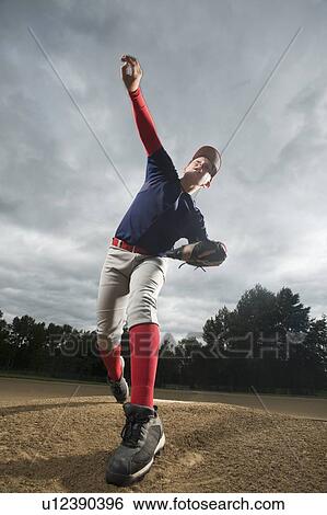 Stock Photograph - Baseball pitcher throwing ball. Fotosearch