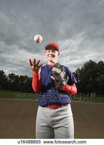 Baseball pitcher tossing ball in air View Large Photo Image Stock Photography - Baseball pitcher tossing ball in air. Fotosearch